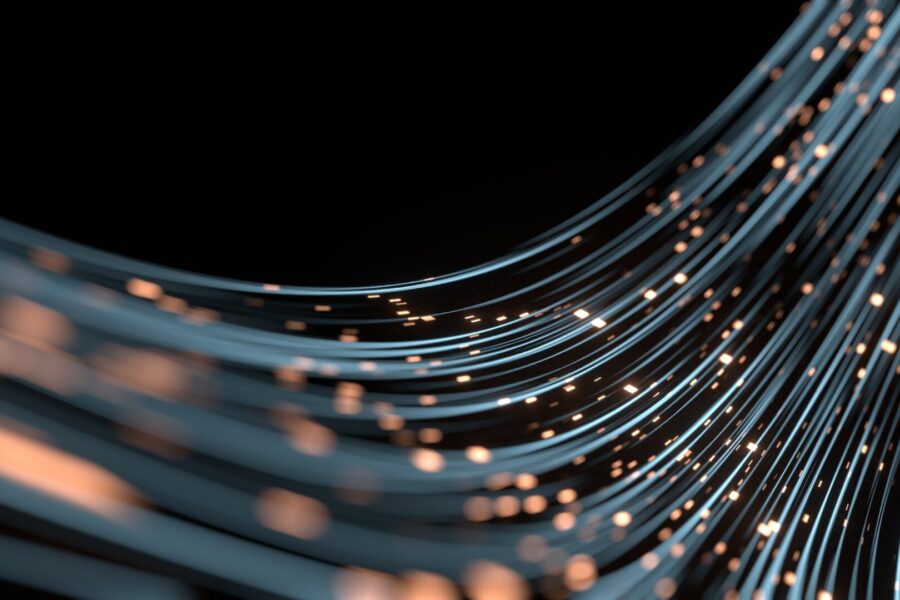 Curved strands of blue and orange light form sweeping lines against a black background, resembling glowing fiber optic cables or abstract data streams with small illuminated dots scattered throughout.