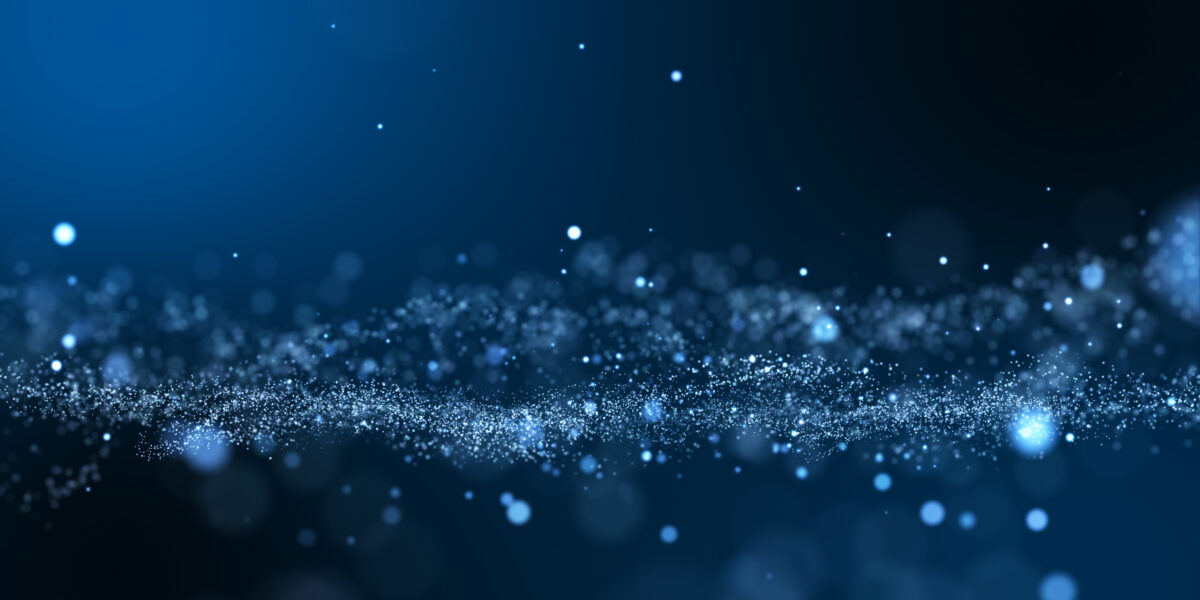 A swirl of glowing blue particles floats against a dark blue background, creating a dreamy, abstract effect that resembles a starry night or a cluster of light in motion.