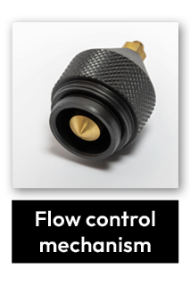 A close-up of a metallic flow control mechanism with a textured grip and a conical brass tip, photographed against a plain white background. The label below reads Flow control mechanism.