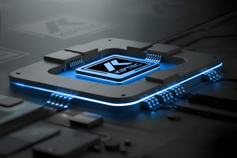 A futuristic computer chip with glowing blue edges and circuit lines, featuring the Kotlin logo in the center, sits on a dark, reflective surface.
