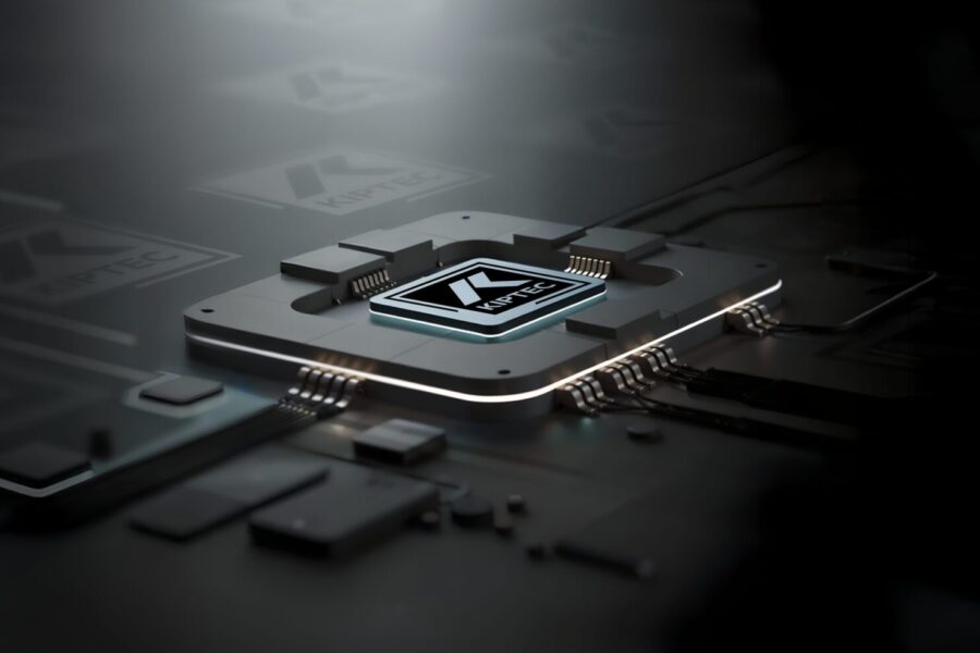 A close-up of a computer chip with glowing edges and circuit connections, featuring a stylized K logo at the center, resting on a dark, futuristic circuit board.