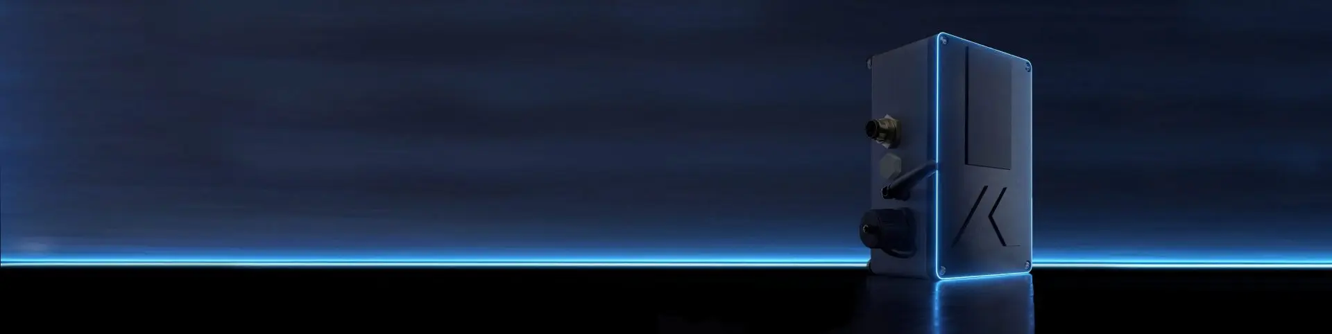 A tall, sleek, dark blue device with subtle lighting accents stands upright on a reflective surface against a dark, gradient blue background with a horizontal glow near the bottom.